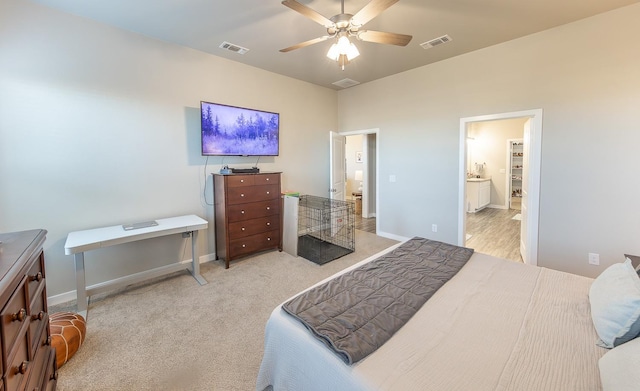 bedroom with connected bathroom, light carpet, and ceiling fan