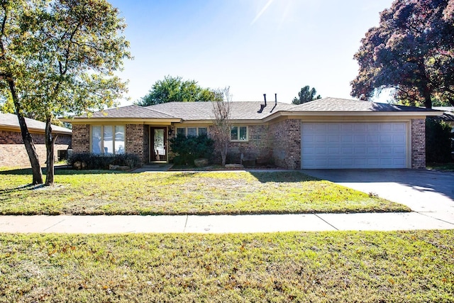 ranch-style house featuring a garage and a front lawn