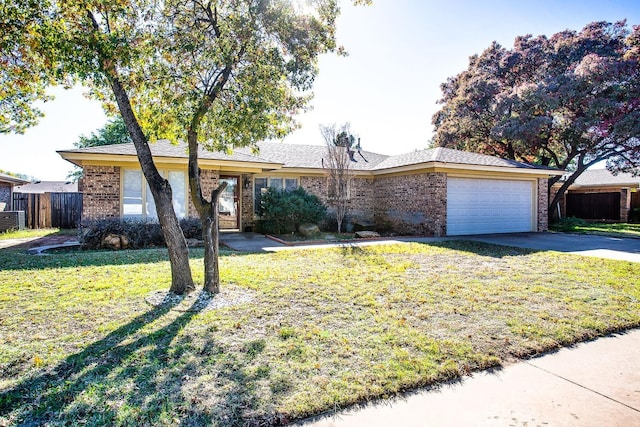 ranch-style house featuring a garage and a front lawn