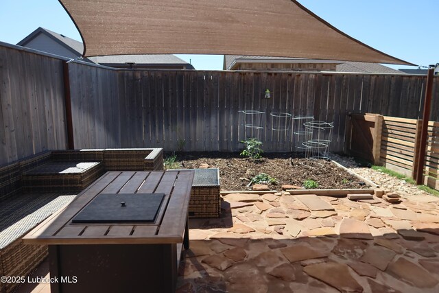 1023 N Fulton Ave, Lubbock, TX 79416 - fenced backyard with a patio area