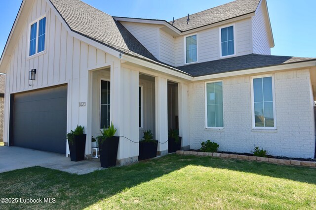 1023 N Fulton Ave, Lubbock, TX 79416 - view of front of home featuring brick siding, board and batten siding, a front lawn, a shingled roof, and an attached garage