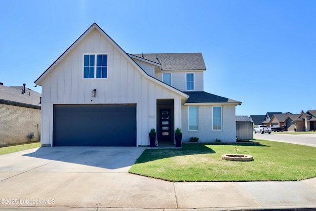 1023 N Fulton Ave, Lubbock, TX 79416 - view of front facade featuring board and batten siding, a front yard, roof with shingles, driveway, and an outdoor fire pit
