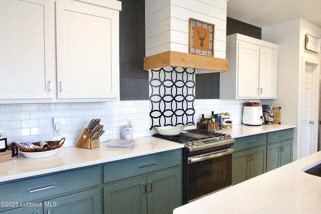 1023 N Fulton Ave, Lubbock, TX 79416 - kitchen with stainless steel gas range oven, light countertops, white cabinetry, and backsplash