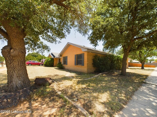 3419 101st St, Lubbock, TX 79423 - view of home's exterior with brick siding