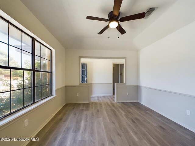 3419 101st St, Lubbock, TX 79423 - empty room with wood finished floors and ceiling fan