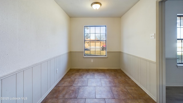 3419 101st St, Lubbock, TX 79423 - unfurnished room featuring healthy amount of natural light and wainscoting