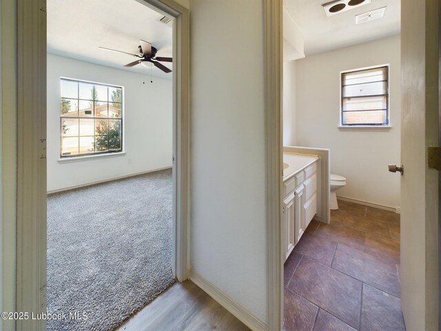 3419 101st St, Lubbock, TX 79423 - bathroom featuring ceiling fan, vanity, and healthy amount of natural light