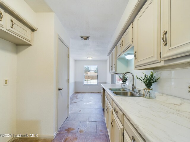 3419 101st St, Lubbock, TX 79423 - kitchen with cream cabinetry and backsplash