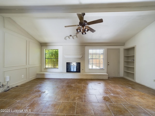 3419 101st St, Lubbock, TX 79423 - unfurnished living room featuring lofted ceiling, a brick fireplace, built in features, and a ceiling fan