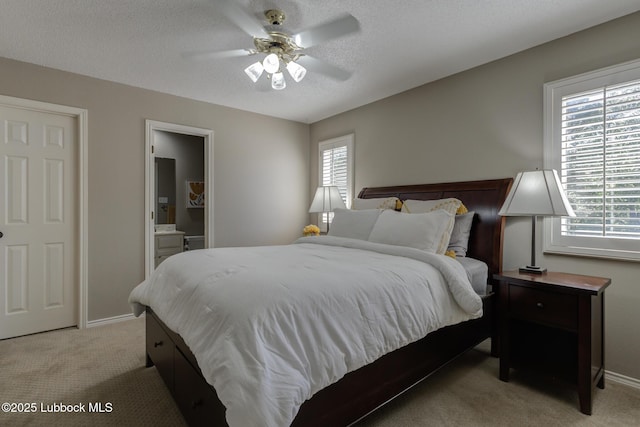 9406 Wayne Ave, Lubbock, TX 79424 - bedroom with light colored carpet, baseboards, a textured ceiling, a ceiling fan, and ensuite bath