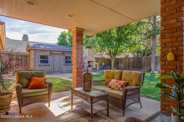 9406 Wayne Ave, Lubbock, TX 79424 - fenced backyard with an outdoor living space with a fireplace and a patio area