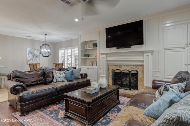 9406 Wayne Ave, Lubbock, TX 79424 - living area with ceiling fan, a chandelier, wood finished floors, built in shelves, and recessed lighting