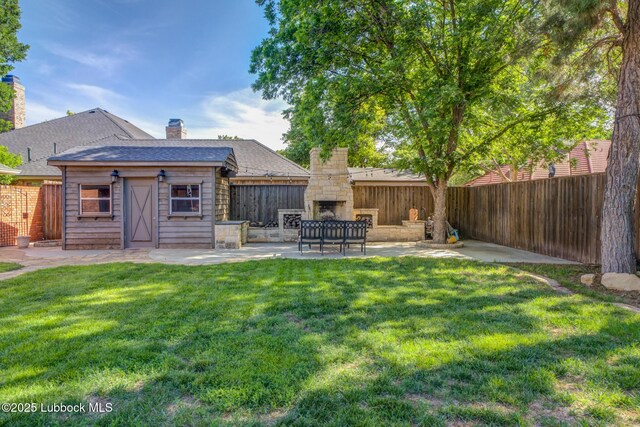 9406 Wayne Ave, Lubbock, TX 79424 - view of yard with an outdoor stone fireplace, a patio, and an outbuilding