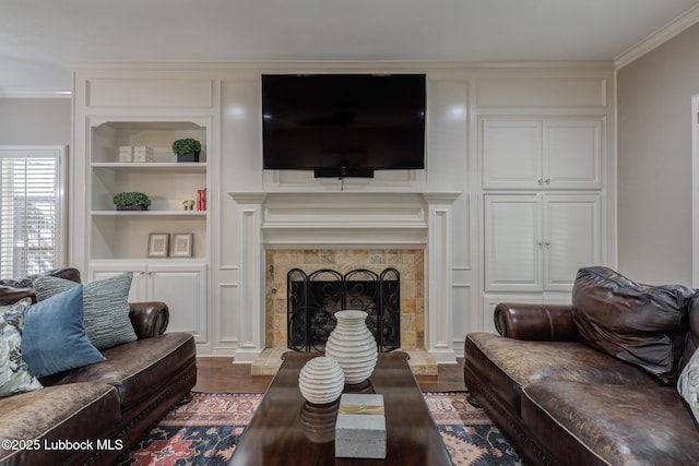 9406 Wayne Ave, Lubbock, TX 79424 - living room featuring dark wood-style flooring, built in shelves, crown molding, and a fireplace