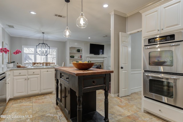 9406 Wayne Ave, Lubbock, TX 79424 - kitchen with appliances with stainless steel finishes, wood counters, crown molding, white cabinetry, and pendant lighting