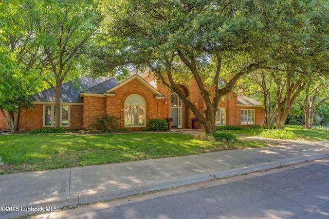 9406 Wayne Ave, Lubbock, TX 79424 - view of front of house with a front lawn and brick siding