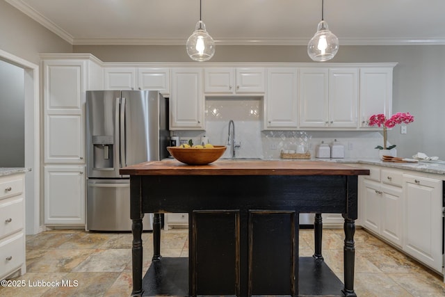9406 Wayne Ave, Lubbock, TX 79424 - kitchen featuring stainless steel fridge with ice dispenser, decorative backsplash, white cabinetry, ornamental molding, and pendant lighting