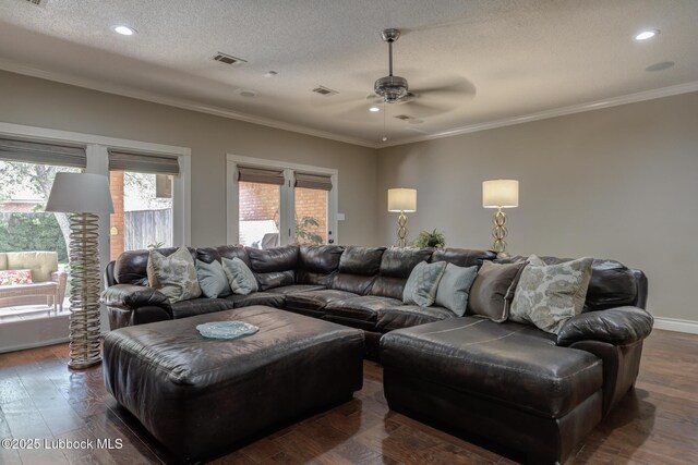 9406 Wayne Ave, Lubbock, TX 79424 - living area with a ceiling fan, crown molding, a textured ceiling, dark wood-type flooring, and recessed lighting