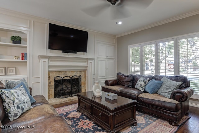 9406 Wayne Ave, Lubbock, TX 79424 - living area with ceiling fan, wood finished floors, built in shelves, plenty of natural light, and crown molding