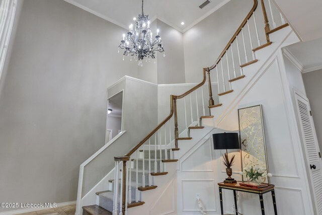 9406 Wayne Ave, Lubbock, TX 79424 - staircase with a towering ceiling, ornamental molding, and a chandelier