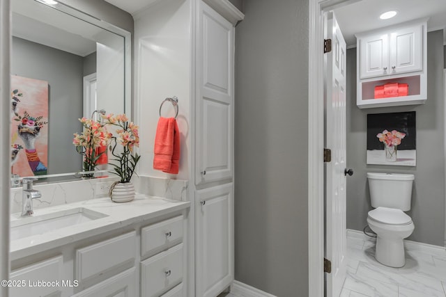 9406 Wayne Ave, Lubbock, TX 79424 - bathroom featuring marble look tile flooring, vanity, toilet, and baseboards
