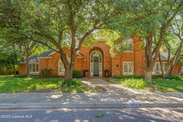 9406 Wayne Ave, Lubbock, TX 79424 - view of front facade with a front lawn and brick siding