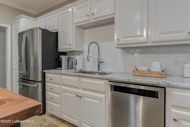 9406 Wayne Ave, Lubbock, TX 79424 - kitchen with stainless steel appliances, a sink, backsplash, white cabinets, and crown molding