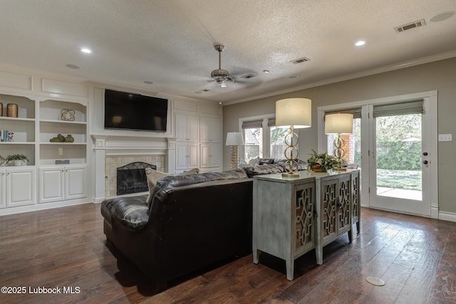 9406 Wayne Ave, Lubbock, TX 79424 - living area featuring a textured ceiling, a ceiling fan, plenty of natural light, ornamental molding, and a fireplace