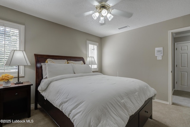9406 Wayne Ave, Lubbock, TX 79424 - carpeted bedroom with multiple windows, a textured ceiling, baseboards, and a ceiling fan