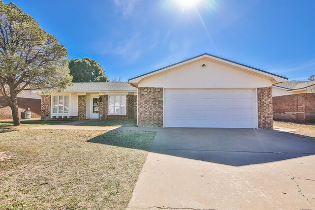 ranch-style house featuring a garage and a front lawn