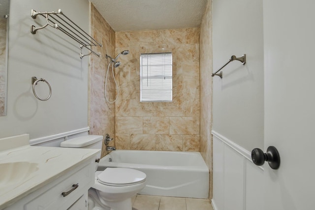 full bathroom with toilet, a textured ceiling, vanity, tiled shower / bath combo, and tile patterned flooring