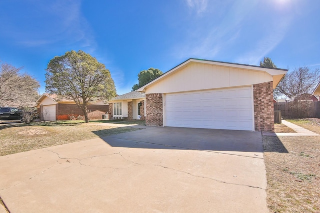 single story home with cooling unit and a garage