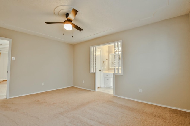 unfurnished room featuring light carpet and ceiling fan