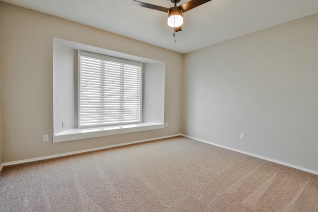 empty room with carpet floors and ceiling fan