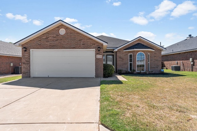 single story home featuring a garage, central AC unit, and a front lawn