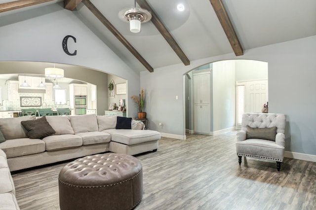 living room featuring beamed ceiling, high vaulted ceiling, and hardwood / wood-style flooring