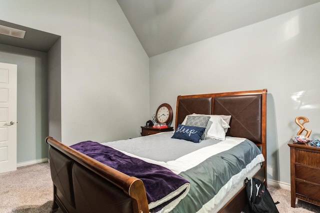 bedroom with vaulted ceiling and carpet flooring