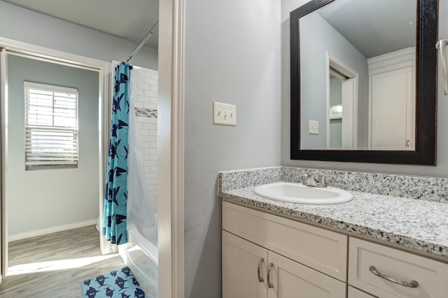 bathroom with vanity, wood-type flooring, and shower / bath combo