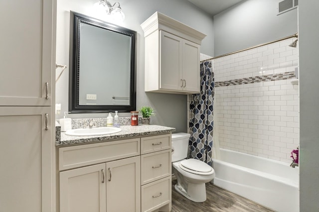 full bathroom featuring vanity, toilet, wood-type flooring, and shower / bath combo