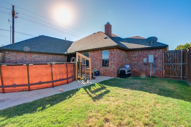 back of property featuring a yard and a patio area