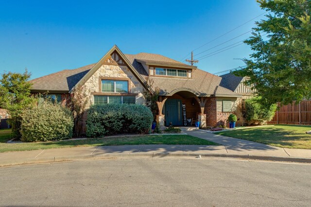 tudor home featuring a front yard