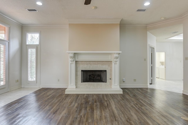 4107 101st St, Lubbock, TX 79423 - unfurnished living room featuring wood finished floors, crown molding, a fireplace, ceiling fan, and recessed lighting