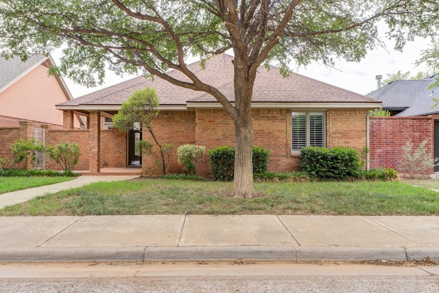 4107 101st St, Lubbock, TX 79423 - ranch-style house with a shingled roof, brick siding, and a front lawn