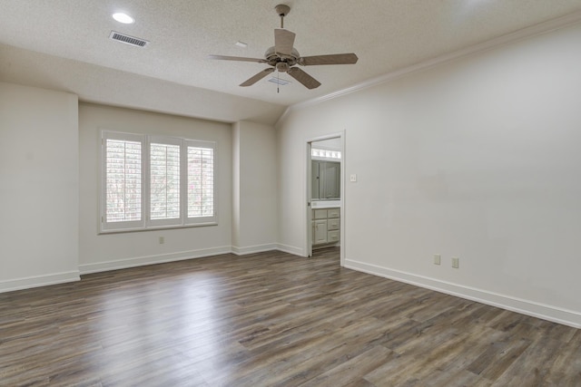 4107 101st St, Lubbock, TX 79423 - spare room with a ceiling fan, ornamental molding, dark wood-style flooring, a textured ceiling, and recessed lighting