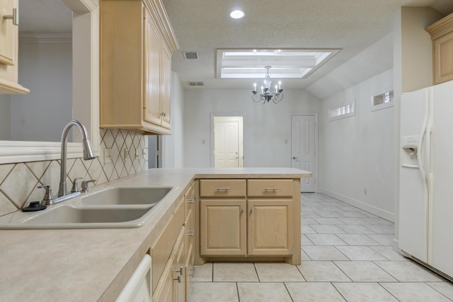 4107 101st St, Lubbock, TX 79423 - kitchen with white fridge with ice dispenser, light brown cabinets, light countertops, backsplash, and a peninsula