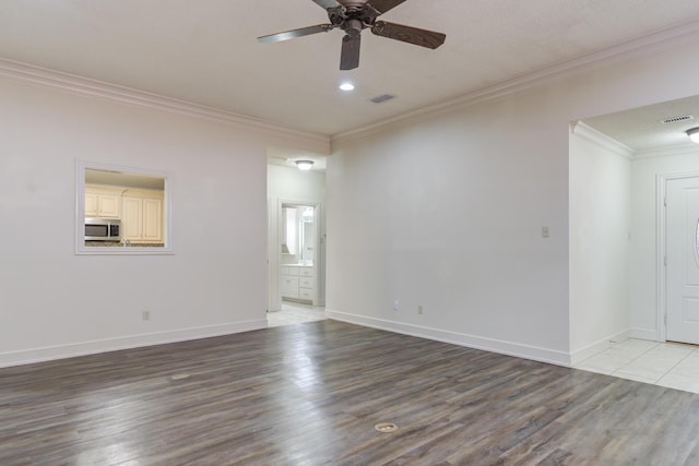 4107 101st St, Lubbock, TX 79423 - unfurnished room featuring wood finished floors, a ceiling fan, and ornamental molding