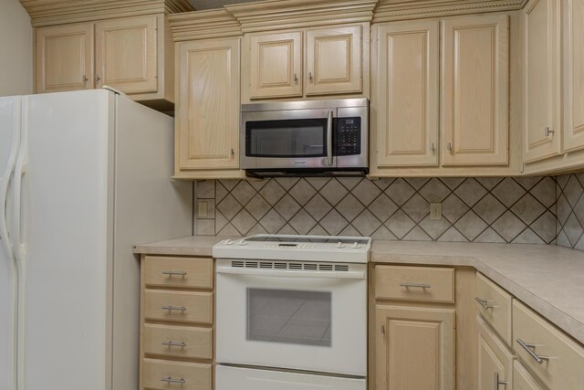 4107 101st St, Lubbock, TX 79423 - kitchen with white appliances, light countertops, and backsplash
