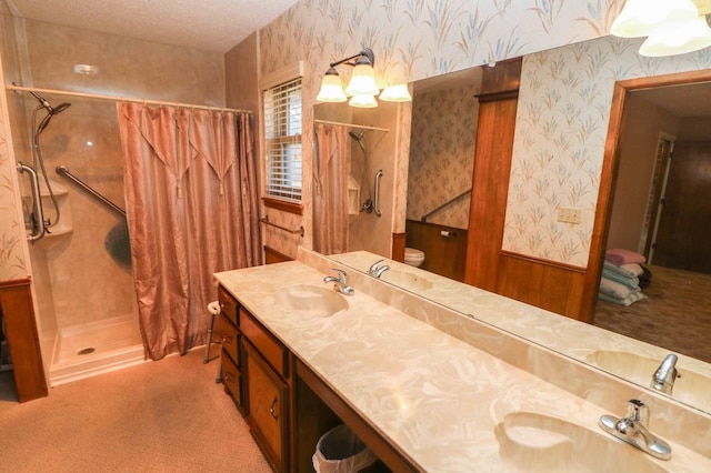 bathroom featuring vanity, curtained shower, a textured ceiling, and toilet