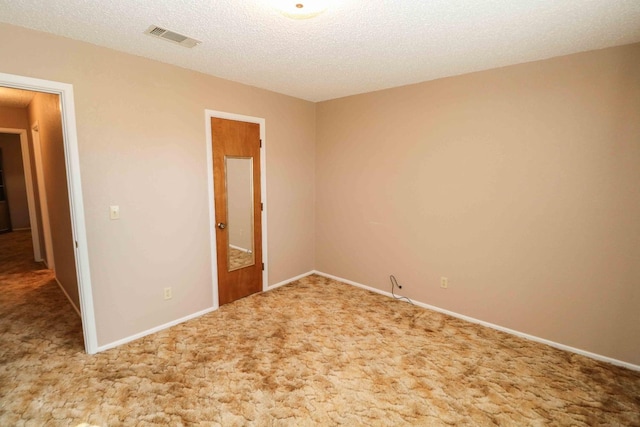 unfurnished bedroom featuring carpet floors and a textured ceiling