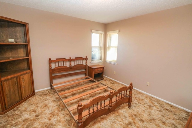 carpeted bedroom featuring a textured ceiling